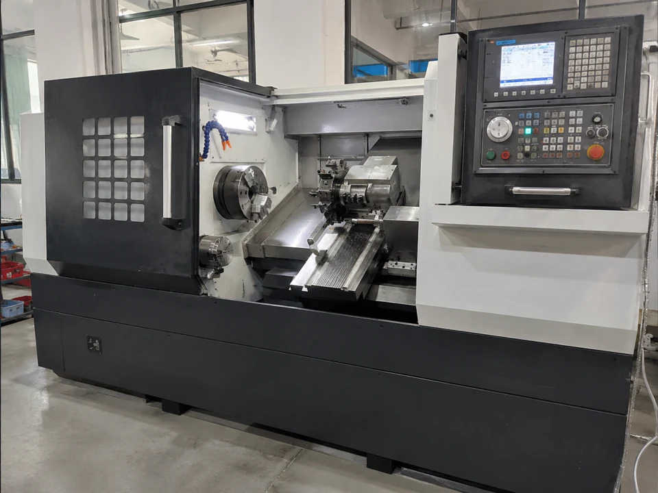 CNC turning lathe showing the chuck, tool turret and machine control panel