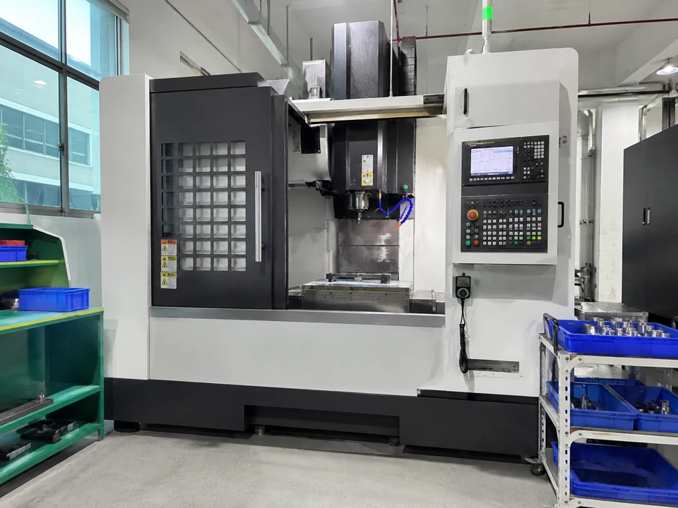 Vertical CNC machining center with an open enclosure and control panel